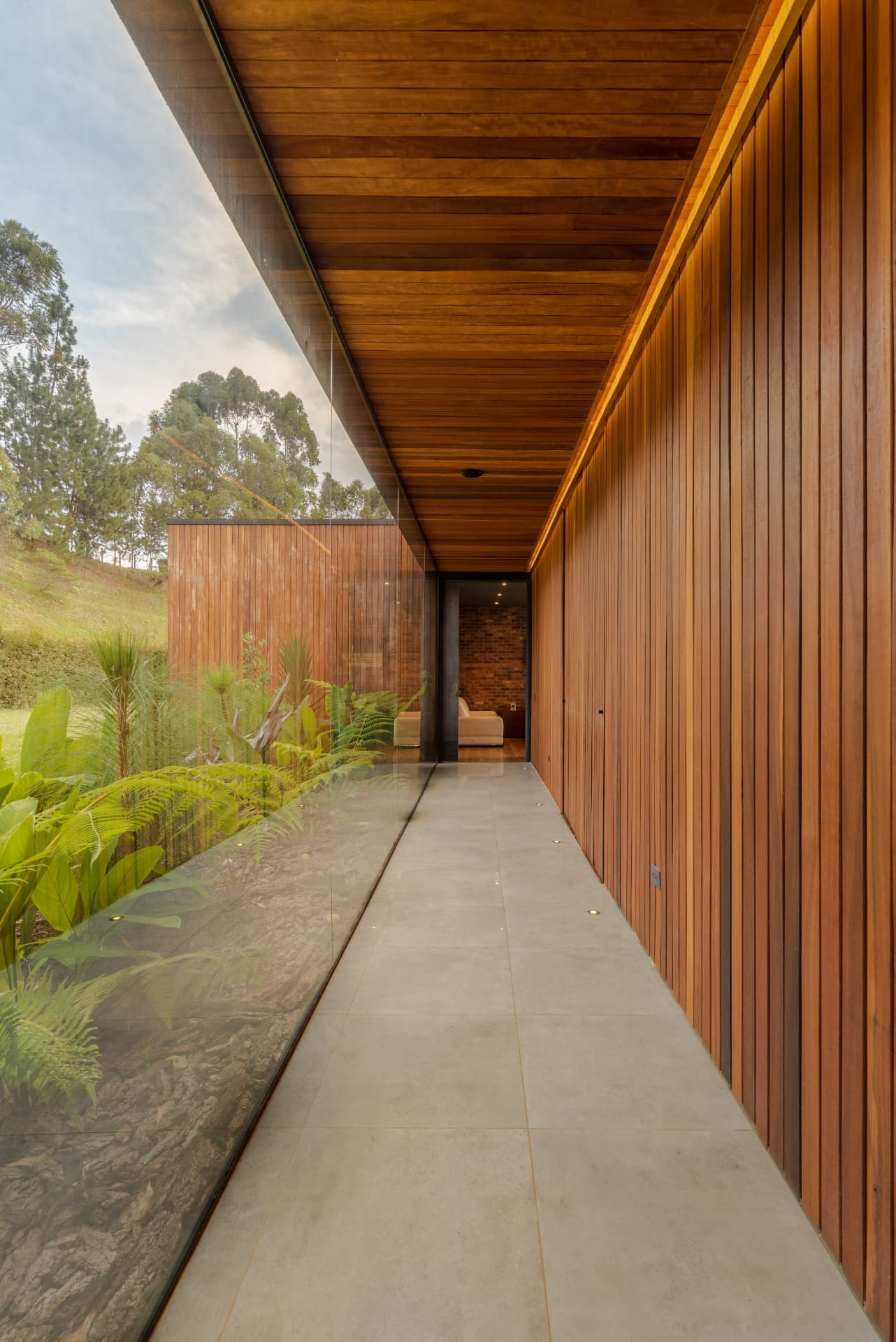Corredor de Pontevedra con techo y muro de madera y paño de vidrio al jardín